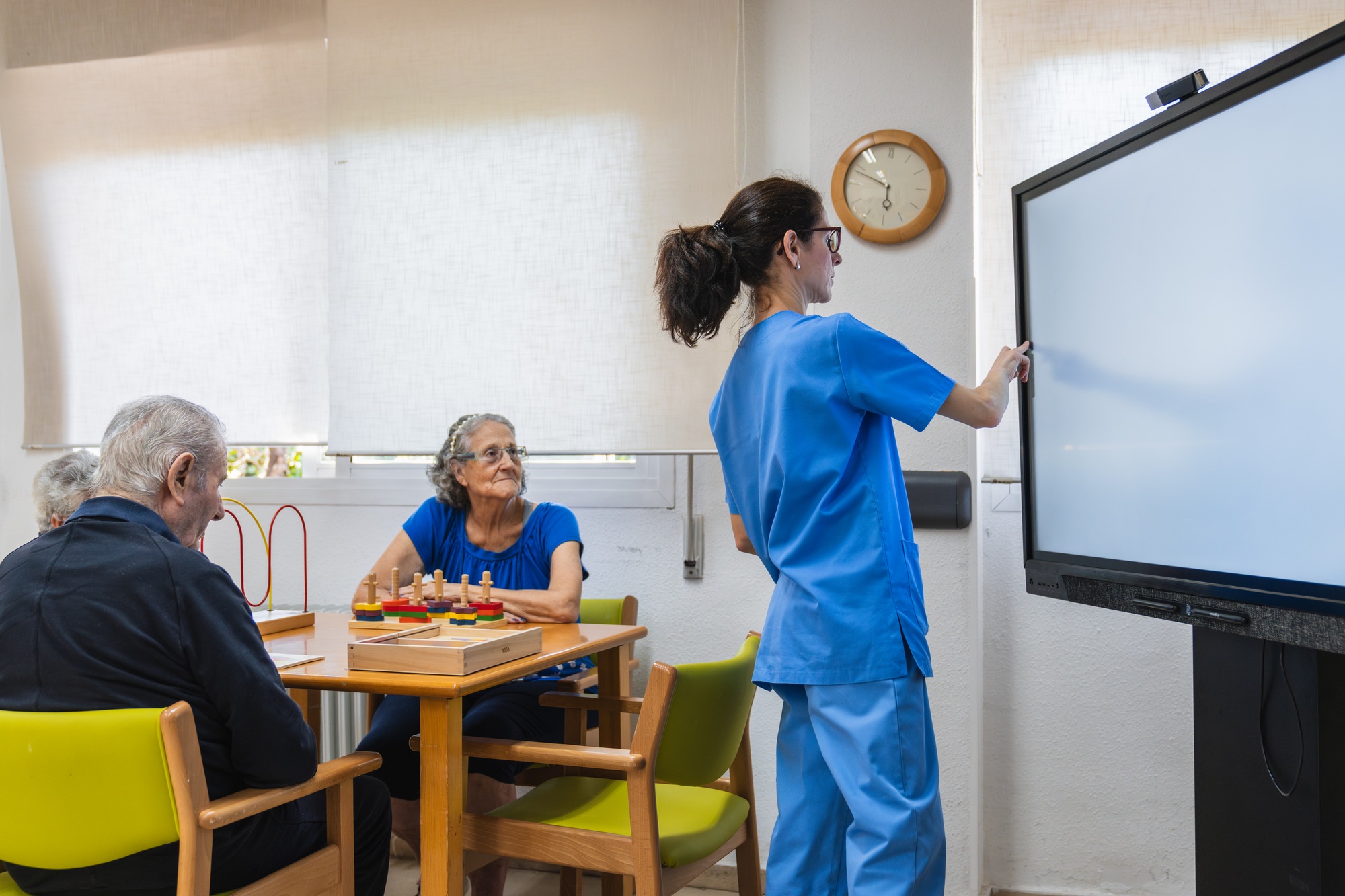 Caregiver assisting elderly residents in nursing home